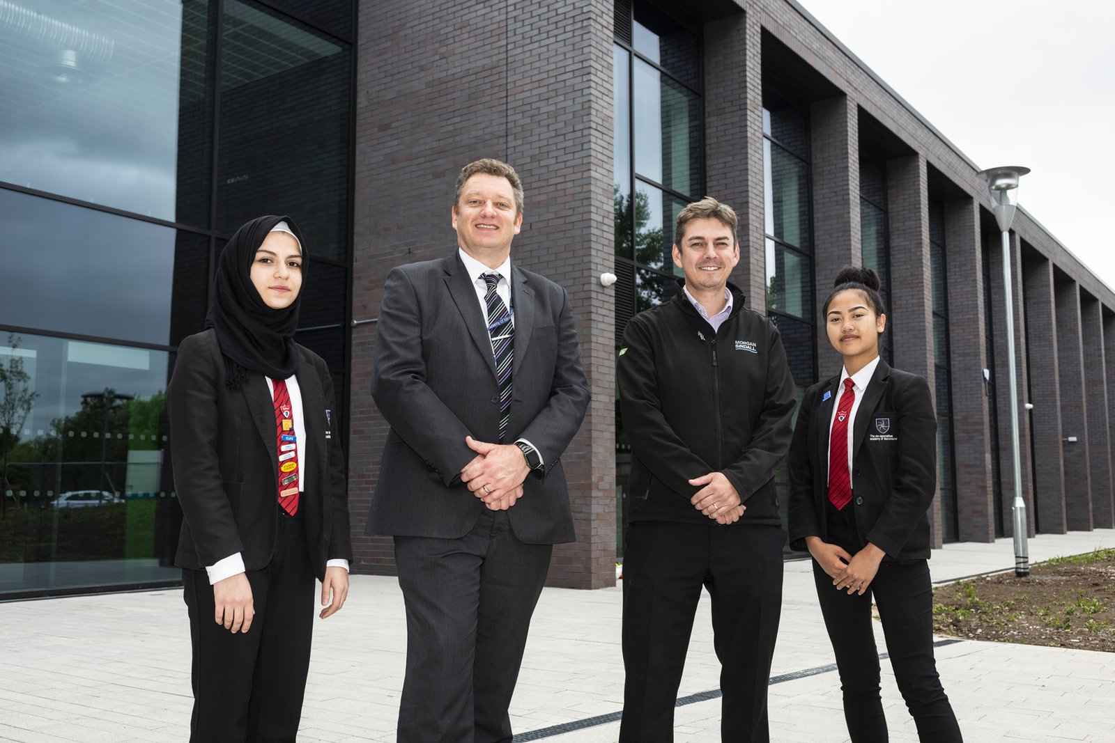 Students from the Co-operative Academy in Manchester outside the front entrance to their new building