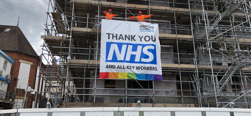 Banner to support the NHS which is attached to the scaffold at the Trinity College project