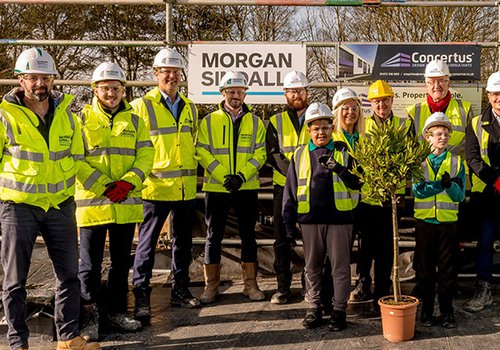 Group of pupils and staff and the Morgan Sindall Construction team at The Bridge School topping out event