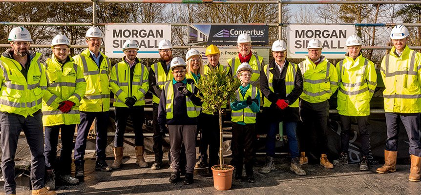 Group of pupils and staff and the Morgan Sindall Construction team at The Bridge School topping out event