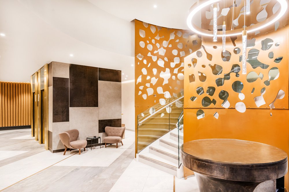 Interior of Great Central Square, Leicester (Project Medius), the decoration of the hotel features gold and white themed materials and colour