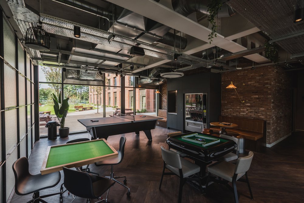 Inside of VITA games room with table games and a table tennis area