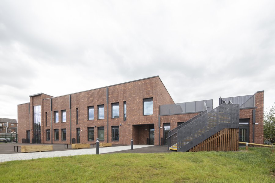 The back of the school building with stairs to a rooftop playground