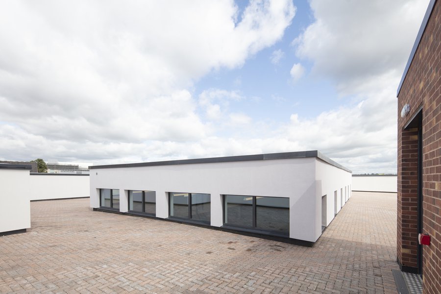 The rooftop playground at Castleward School with block paving