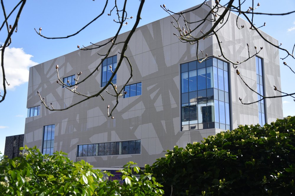 The front part of Southampton Solent Sports complex, which is adjacent to a park area. The mesh cladding features a geometric pattern