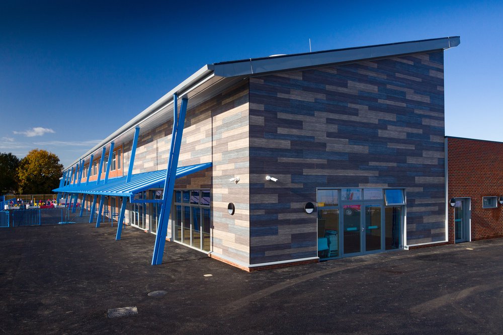 Side view of Hailsham Primary school showing the grey, cream and blue cladding