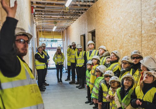 Image of a school site tour as part of a topping out event