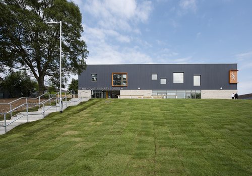 Image of the completed St Nicholas' School in Scotland, with grey cladding to the top and brickwork to the bottom