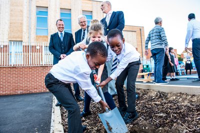 A group of children at a ribbon cutting event at Magna Carta School in Stanstead