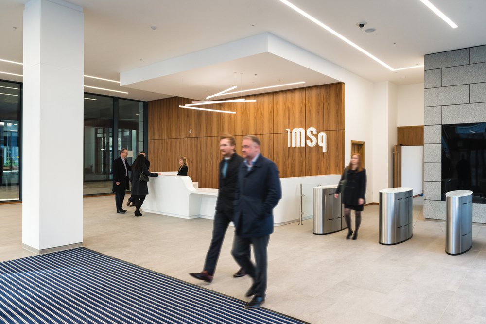 Two men walking through a reception area in one of the office buildings in Marischal Square in Aberdeen