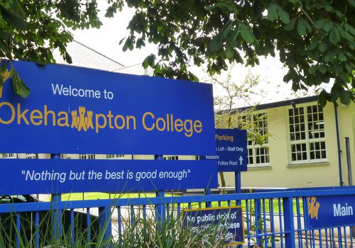Image of the front of Okehampton School in Devon showing the school signage