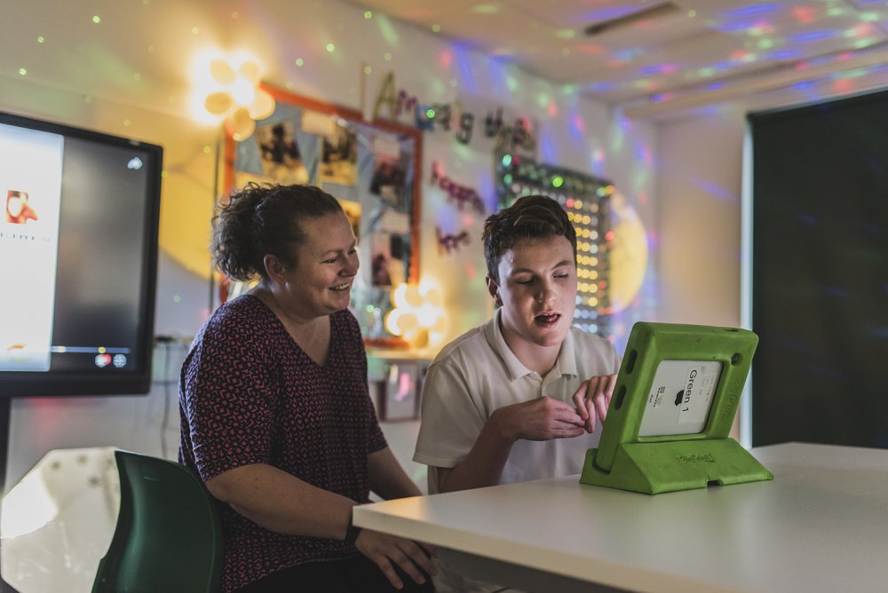 Image of a teacher and child at Glenwood SEN School, working on an ipad in their classroom