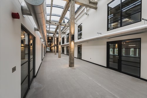 View of the corridor of the Sawston Unity Campus building, which is made light and airy due to the glass panel roof