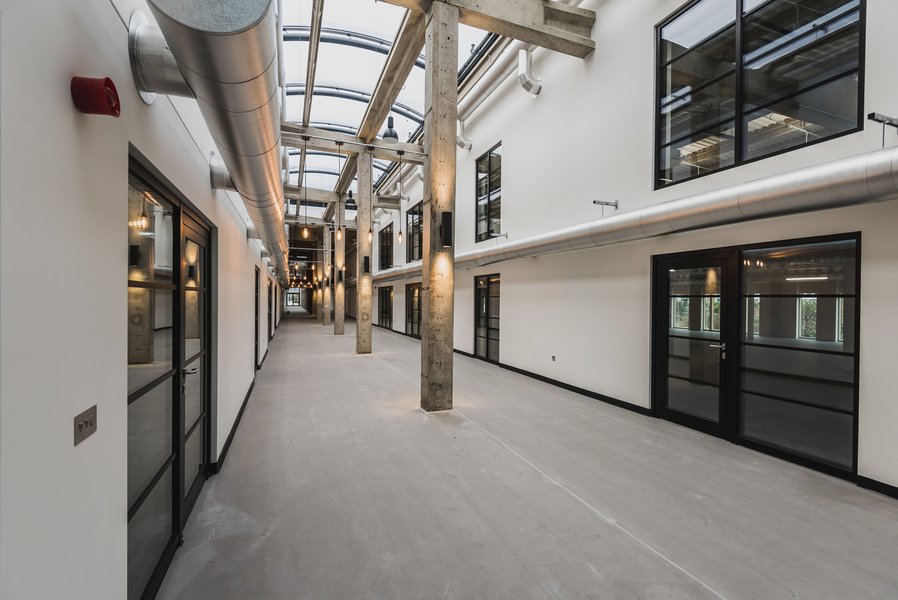 View of the corridor of the Sawston Unity Campus building, which is made light and airy due to the glass panel roof