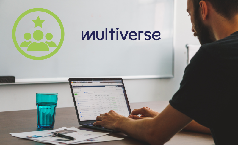 A photograph of a man sat at a desk, using a computer. The Multiverse logo is displayed as part of the image.