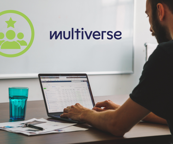 A photograph of a man sat at a desk, using a computer. The Multiverse logo is displayed as part of the image.