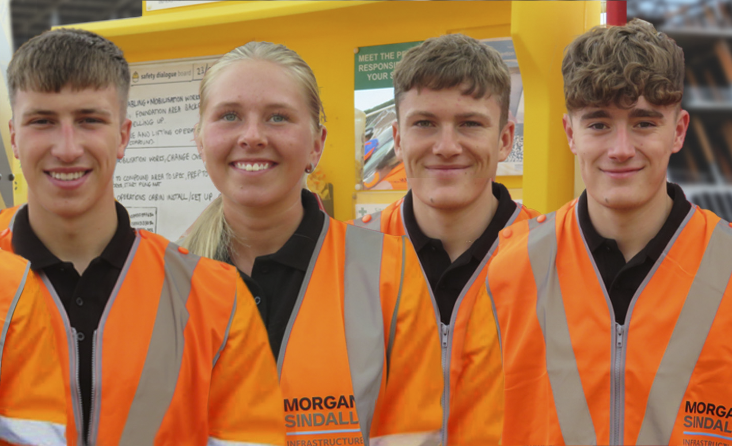 Five Morgan Sindall Infrastructure apprentices stand in a row, smiling, wearing Personal Protective Equipment