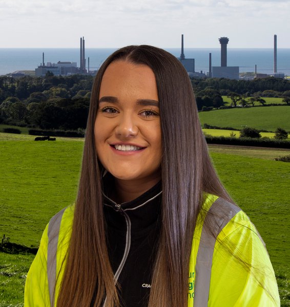 A photograph of Morgan Sindall Infrastructure employee Lauren Moore, wearing Personal Protective Equipment and smiling at the camera