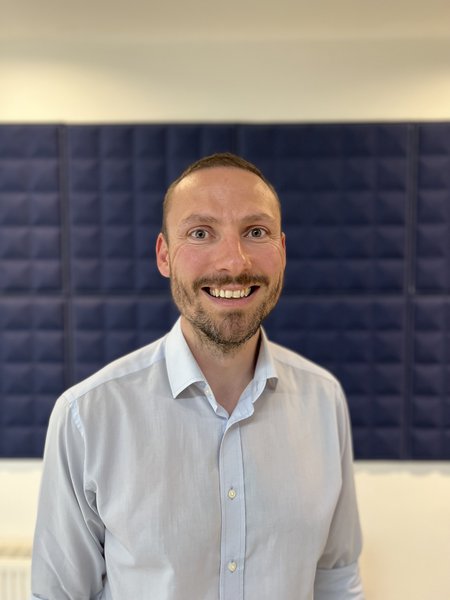 A Morgan Sindall Infrastructure employee stands smiling at the camera