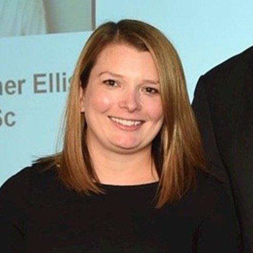 Morgan Sindall Infrastructure colleague Michelle Russ stands holding an award, smiling at the camera